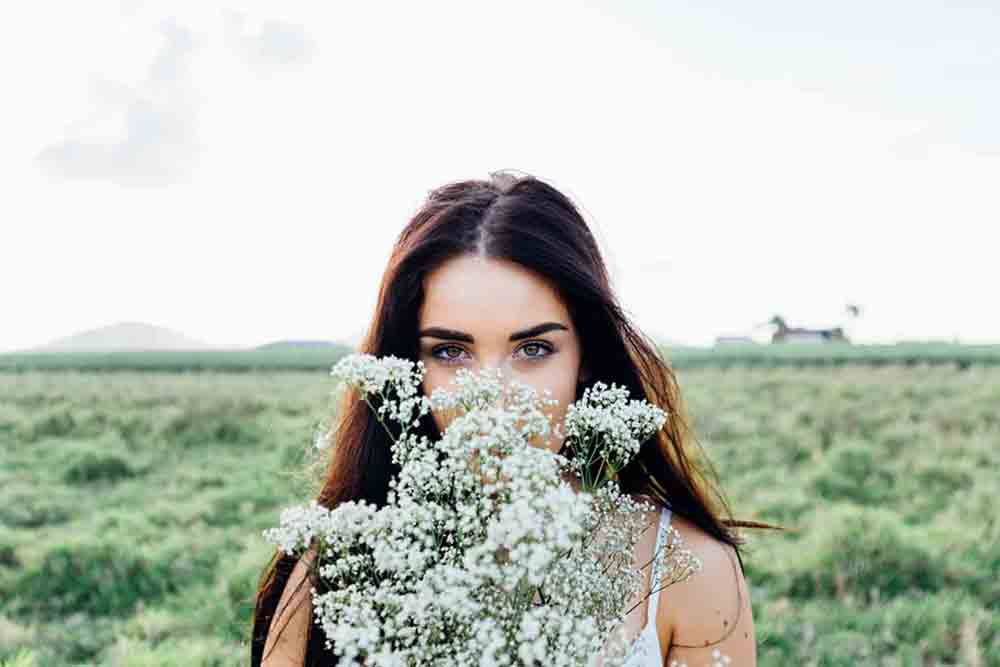 A picture of a beautiful Russian woman holding some flowers