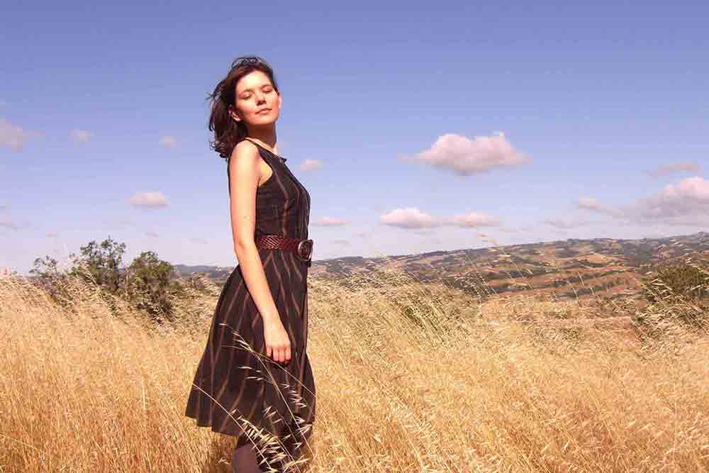 A Russian woman standing in the field.